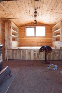 Bigger windows and built in furniture for the little bunkhouse. Our neighbour gave us the beautiful distressed wool from her old grain bins!